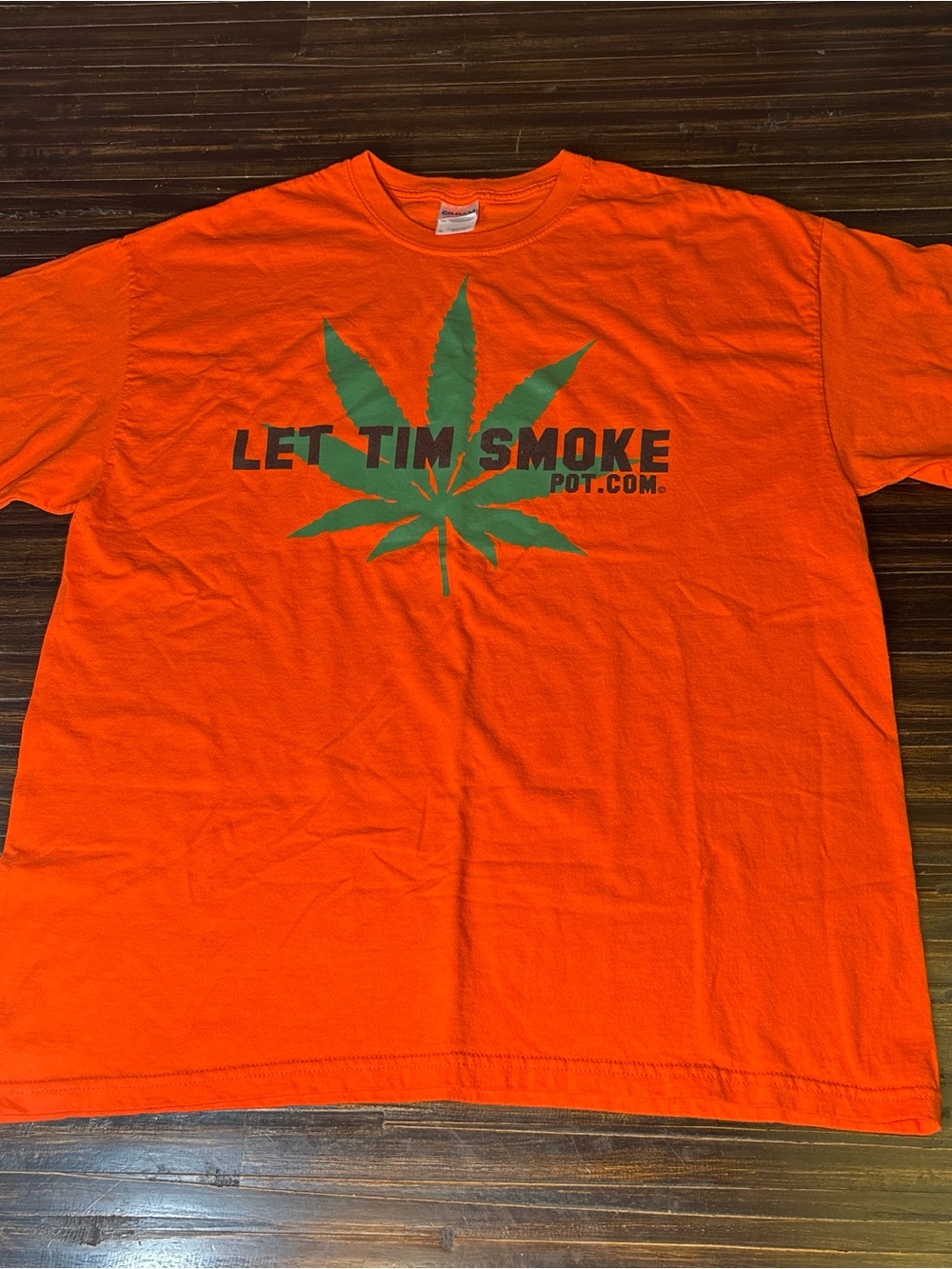 Gildan Orange Tee with Green Leaf Graphic and 'Let Tim Smoke' Text